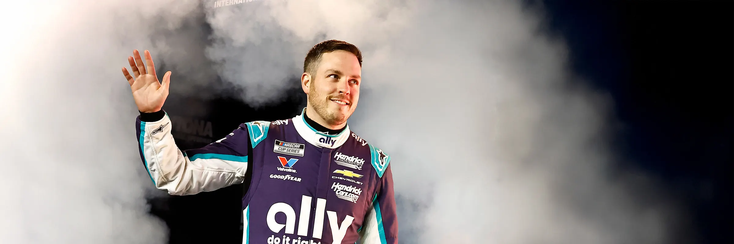 Nascar drvier of the Ally #48, Alex Bowman, steps through smoke waving to crowd before a race