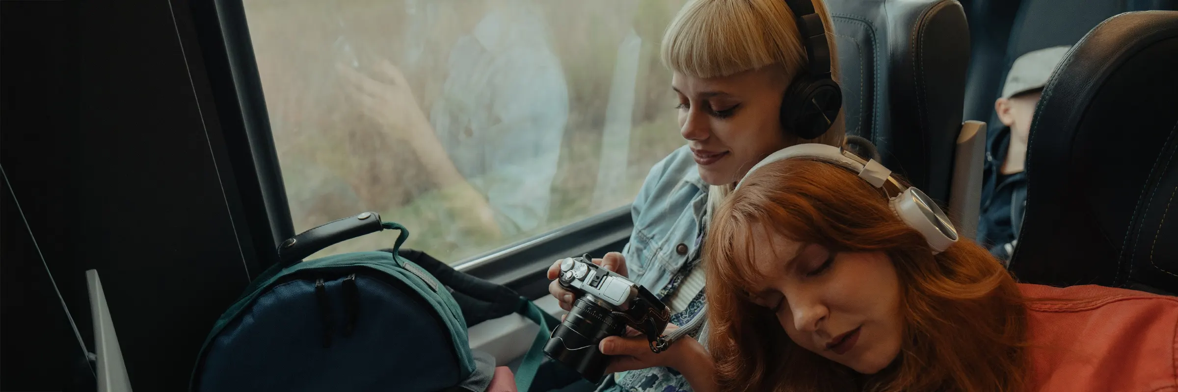  Two people sitting close together on a train ride.  