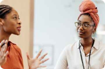 Two people having a discussion while sitting.