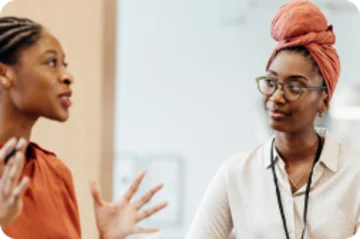 Two people having a discussion while sitting.