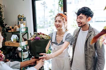 Young couple purchasing fresh flowers at a market