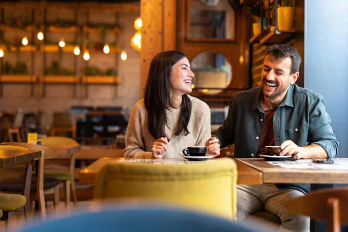 A couple enjoying coffee together at a café