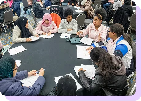 a group of students conversing during a workshop