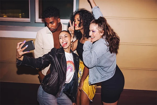 Four friends posing for a selfie.