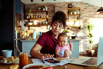A woman with a baby and calculator 