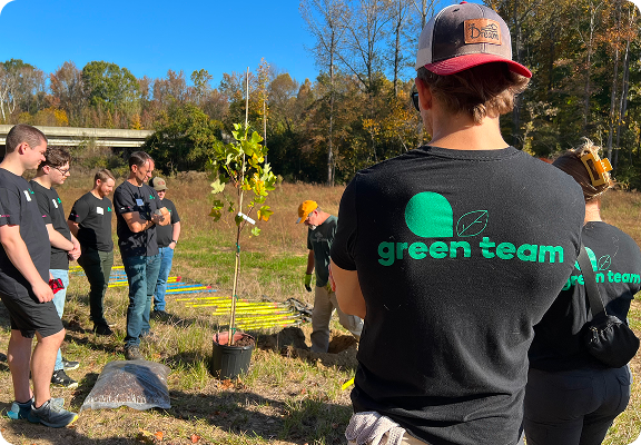 a group of employees planting a tree