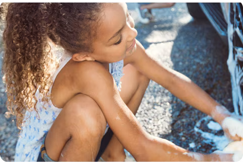 Two children washing car