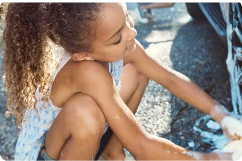 Two children washing car