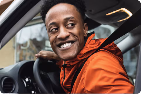 A man inside the car smiling