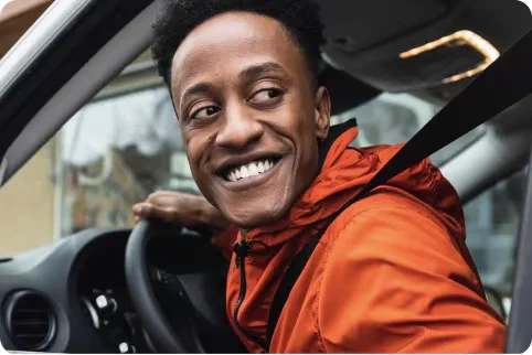 A man inside the car smiling