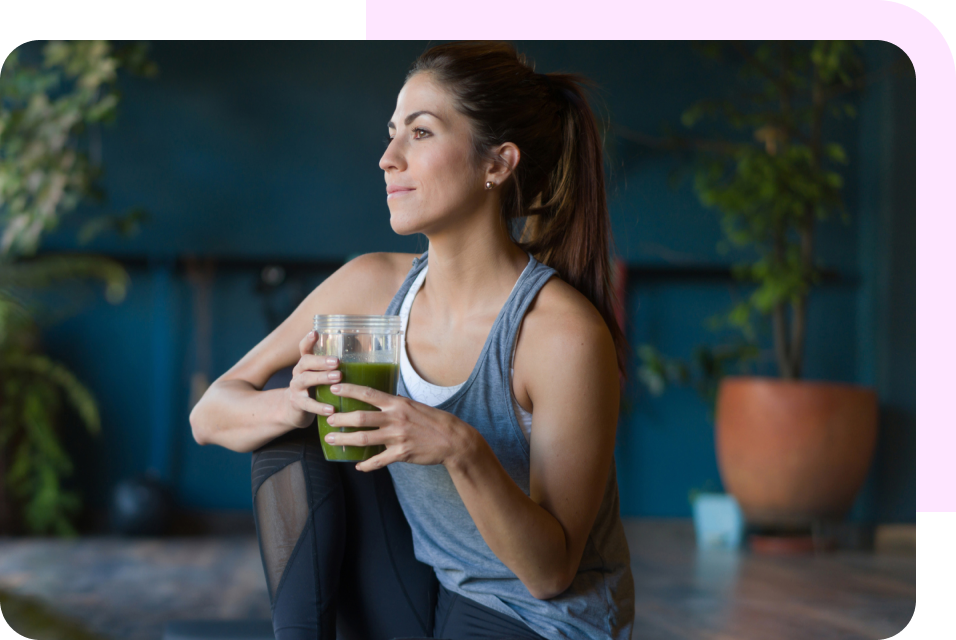 Woman holding green smoothie