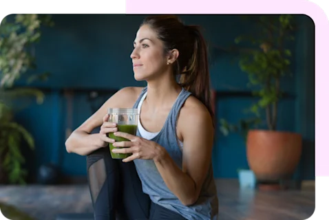 Woman holding green smoothie