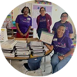 a smiling group of Ally employees displaying financial workbooks.