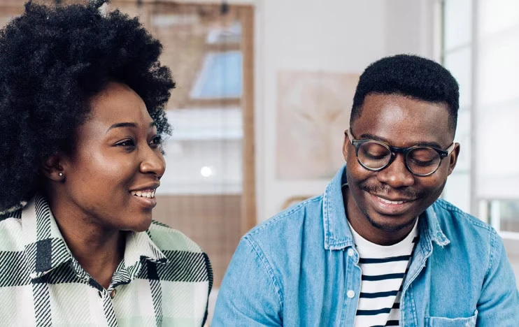 A smiling couple sits at a cafe