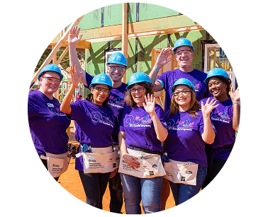 A group smiling Ally employees volunteering at a Habitat for Humanity site.