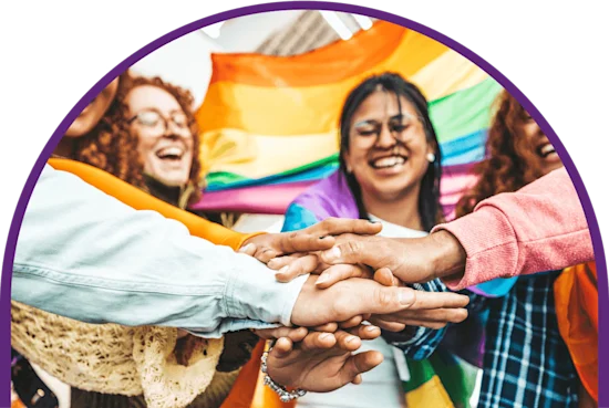 A colorful group of hands meet in the center of a celebratory cheer.